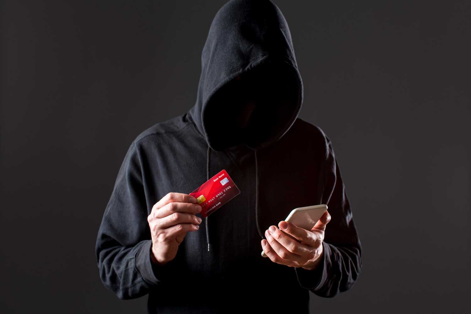 front view male hacker holding smartphone credit card
